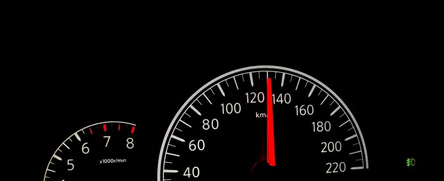 Car dashboard speedometer reaching high speed of 130 kmh in the dark.