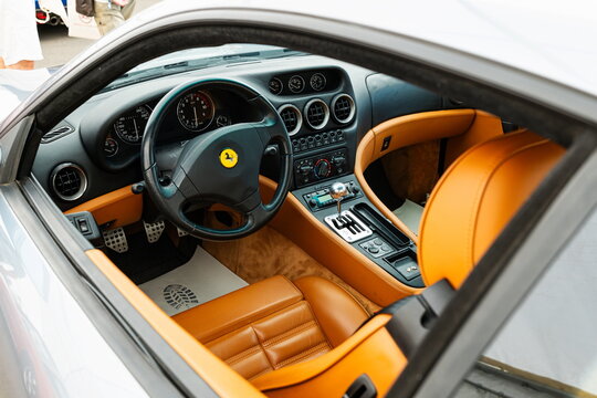 Lucerne, Switzerland, May 30, 2026. Cockpit interior of a silver Ferrari 550 Maranello with tan leather bucket seats.