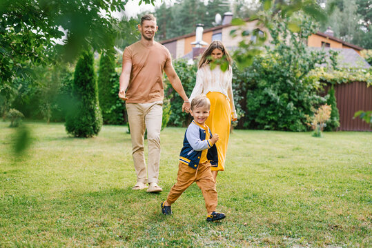 Pregnant Woman Walking With Husband And Son