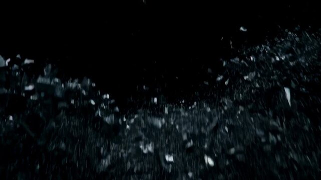 Dark wall shattering into abstract debris exploding in slow motion