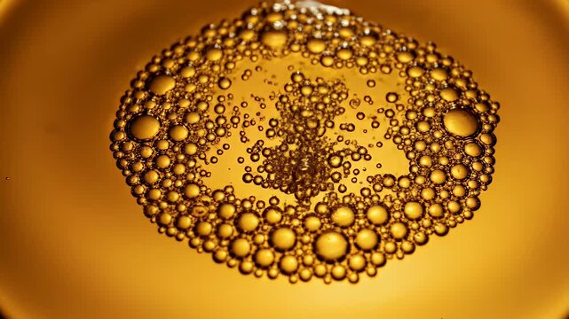 Close-up of golden bubbles clustered together against a softly blurred amber background