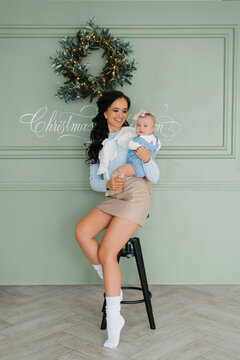 Smiling Mother Holding Baby Girl At Christmas