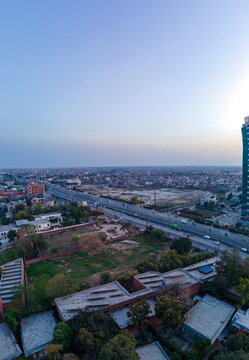 Aerial view of Arfa Software Technology Park and Ferozepur Road with urban sprawl and rooftops under a clear sky in Lahore, Punjab, Pakistan.