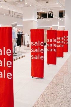 Bright Red Sale Banners Leading Through a Modern Shopping Mall