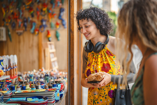 Woman enjoying street market ceramic shopping and local crafts