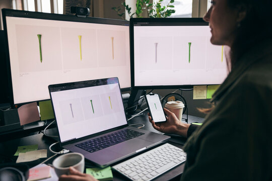 Female tech expert comparing design preview on all technologies while working in startup office