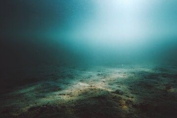 Fototapeta premium Calm, low-visibility seafloor scene with sandy seabed and muted blue-green tones