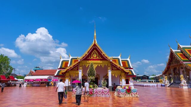 SAKON NAKHON,THAILAND- MAY 31,2026:Time lapse of Buddhists come to pay their respects at Wat Phra That Choeng Chum a major and sacred religious monument of Sakon Nakhon Province in Thailand.