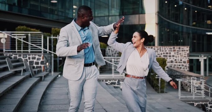 Business people, high five and dancing with smile in city, team and happy for stock market increase. Laughing, wealth manager and celebration with colleague on stairs, rhythm and excited for success