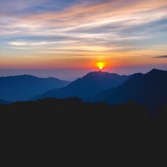 Obraz premium Mountains and Clouds at Sunset in a Clear Sky With Vibrant Colors of Orange and Blue