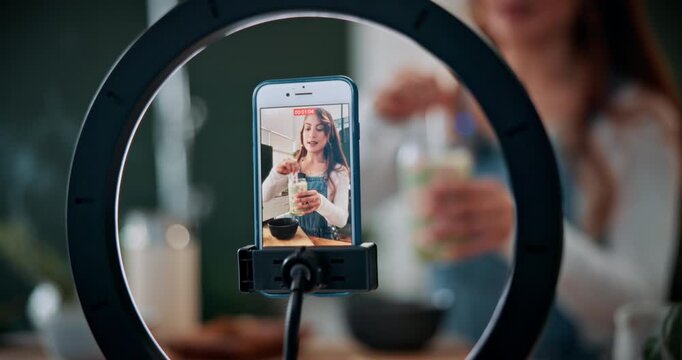 Matcha, content creator and phone screen with woman in home for green tea, wellness influencer and review. Social media, live stream and health drink guide with person and ring light in house