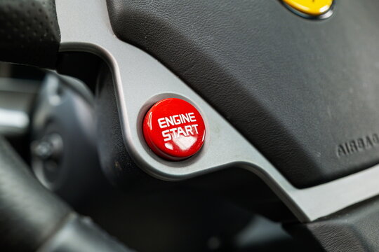 Lucerne, Switzerland, May 30, 2026. Red engine start button on the leather steering wheel of a classic Ferrari F430.