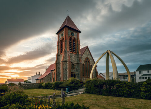 Morning picture of Christ Church Cathedral with famous whalebone arch, dramatic sky and first sun rays, Port Stanley, capital of Falkland Islands, British overseas territory. 