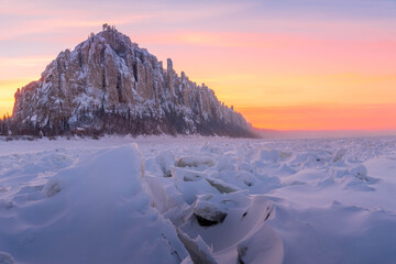 Beautiful Siberia winter sunset over snow covered Lena Pillars above frozen Lena River in Yakutia, Russian Siberia. Iconic rocky formations in vibrant twilight.  © Artaxerxes