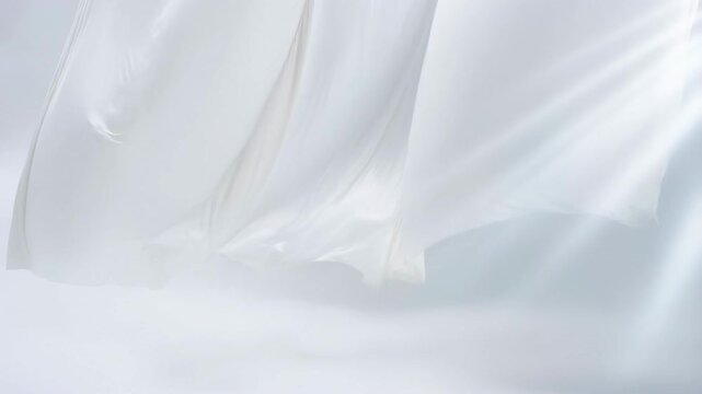 Flowing white fabric in soft breeze creating gentle movement and light play