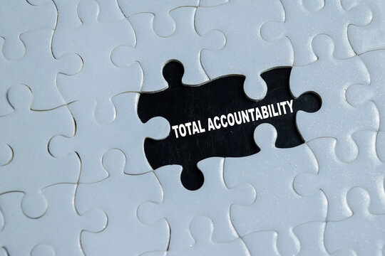 Piece of jigsaw puzzle with word total accountability. For the missing key element for business success