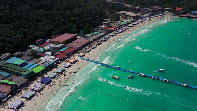 Aerial View of Busy Tropical Beach with Turquoise Water and Boats