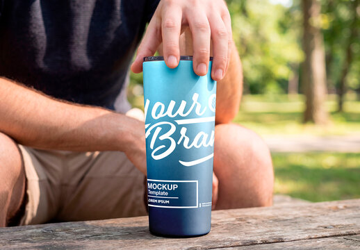 Hand placing lid on blank tumbler cup