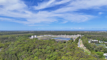 Obraz premium Aerial View of Coombabah Water Treatment Plant Surrounded by Dense Forest
