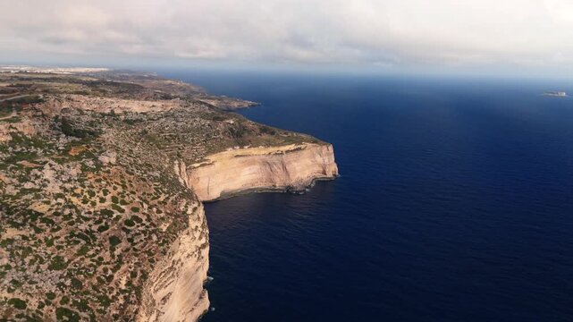 The Dingli Cliffs form a massive natural wall along Malta's isolated western coast, representing the highest point of the Maltese islands at over 250 meters above sea level.