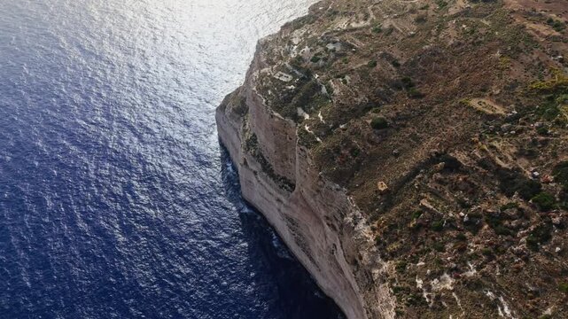 The Dingli Cliffs form a massive natural wall along Malta's isolated western coast, representing the highest point of the Maltese islands at over 250 meters above sea level.