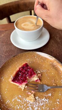 Eating cake and drinking coffee vertical