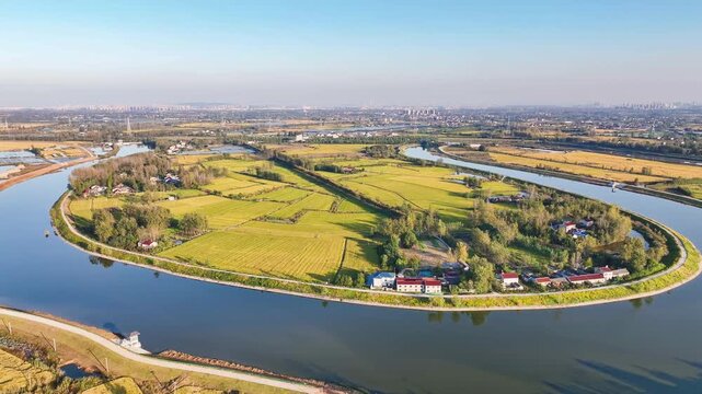 Aerial View of Rural Farmland Surrounded by a Winding River and Small Houses