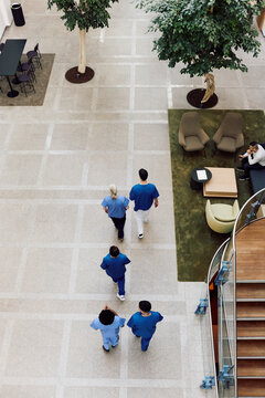 High angle view of medical team walking in hospital lobby