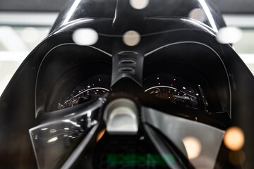 Naklejka premium Darth Vader black helmet macro view with light reflections in mask lenses