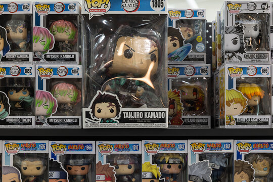 Funko Pop vinyl figures of Tanjiro Kamado and anime characters on shop display shelf