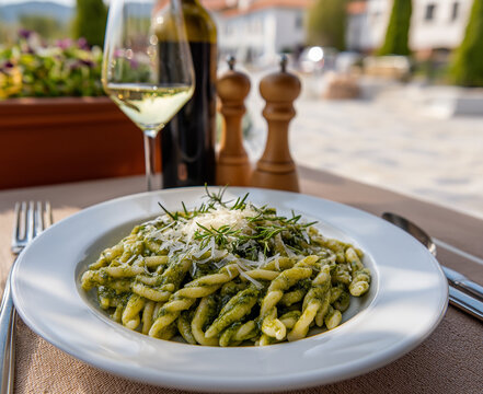 Traditional Trofie al Pesto Served at Italian Restaurant Terrace with White Wine