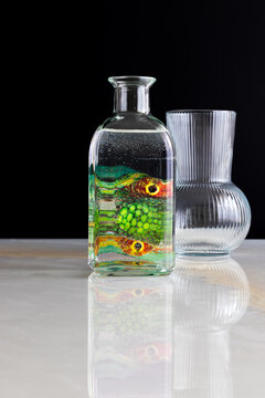 abstract reflection of colorful object inside a glass bottle with water, still life