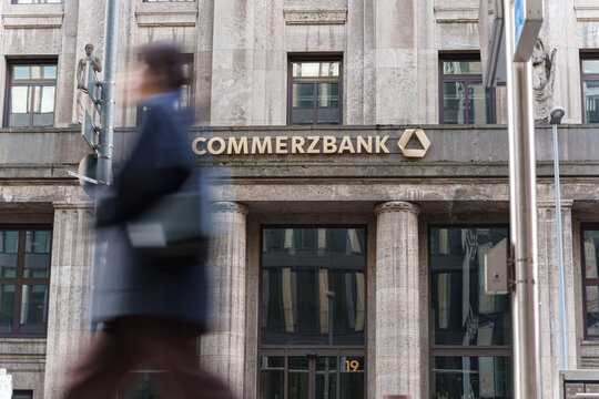 Dusseldorf, Germany - November 2 2025: Commerzbank main branch logo on a historical building in the center of the city with people passing by in motion
