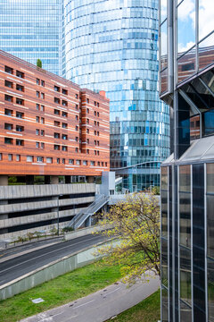 The La Defense district in Paris, France opens around a road, where glass towers and office architecture define the financial urban corridor
