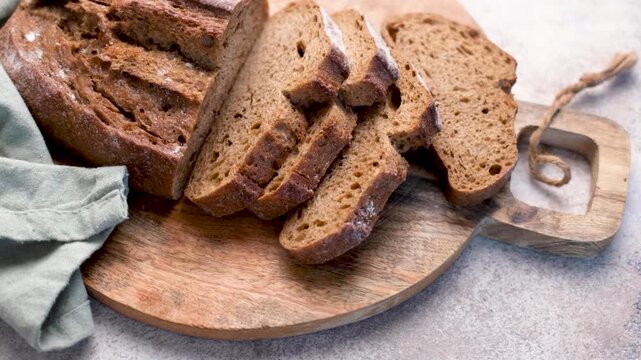 Sliced fresh homemade rye bread on cutting board