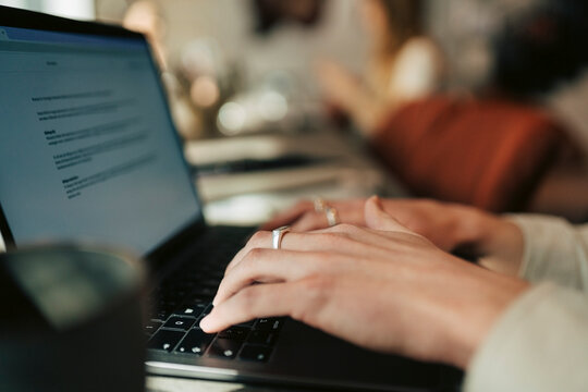 Close-up of businessman preparing documents on laptop at office
