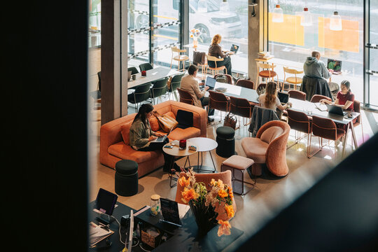 Group of business professionals working together in urban shared workspace