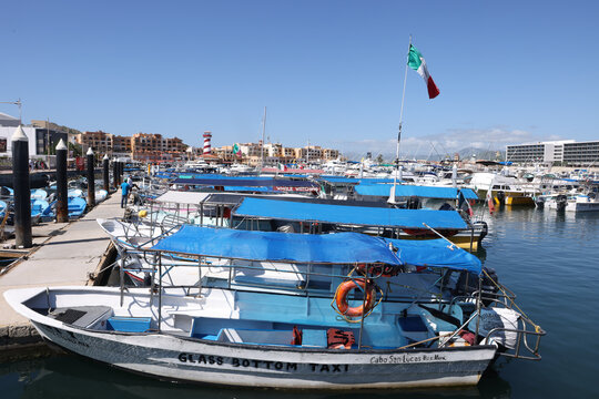 Tourist charter boats, panga boats, and deep sea fishing vessels moored at the docks of the luxury marina in Baja California Sur.