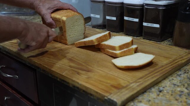 Homemade Bread Being Sliced in a Kitchen