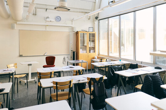 Empty desks and chairs in classroom at junior high school