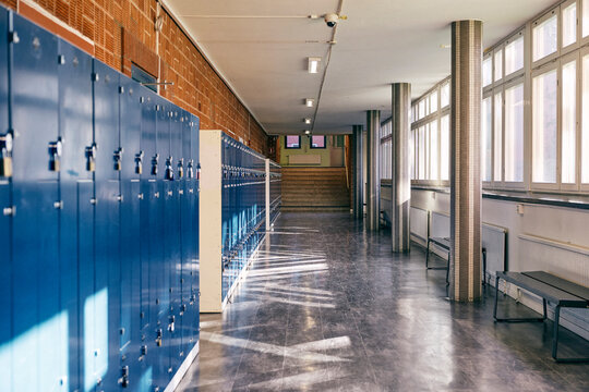 View of junior high school lobby with lockers and benches under window