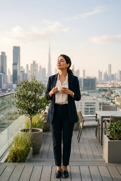 Professional Middle Eastern woman taking peaceful mindful break on office rooftop terrace eyes closed decompressing