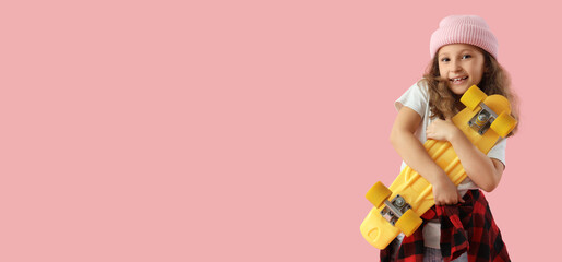 Cute little girl with skateboard on pink background © Pixel-Shot