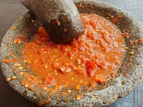 Fresh Indonesian Sambal Chilli Paste Being Ground in a Traditional Stone Mortar and Pestle