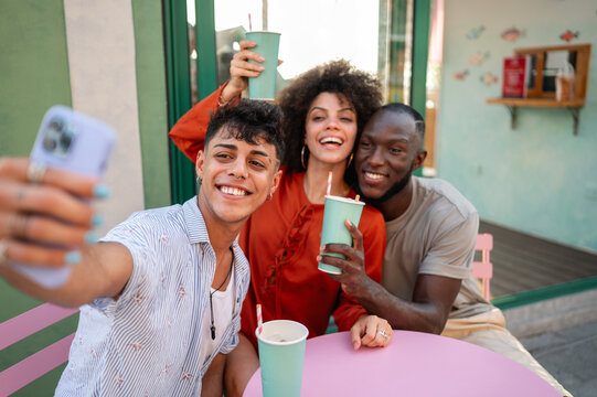 Young friends capture selfie for social media, enjoying time together while expressing creativity