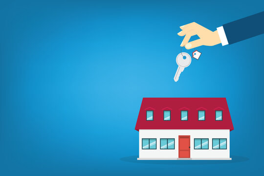 Hand holding key over the house. House buying