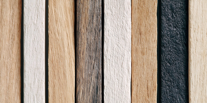 brown wooden acoustic panel texture shows rustic vertical timber slat arrangement creating moody geometric shadow play