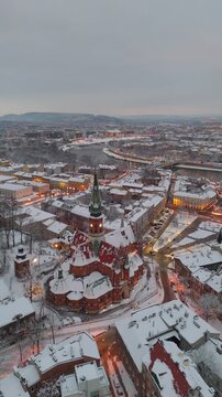 Aerial flyover of St. Joseph's Cathedral in Krakow and the Old Town at sunset in winter