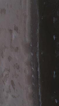 Aerial flyover over the seashore at dawn