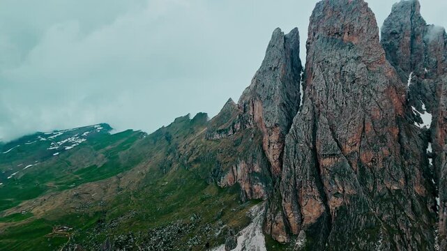 Seceda mountain Odle Geisler Group in Dolomites on cloudy day. Aerial view scenic cloud covered landscape